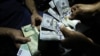 The Iranian rial has been hit hard by U.S. sanctions, which Tehran is going to court to end.