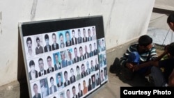 A board in the southern Kyrgyz city of Osh displays pictures of ethnic Uzbek men killed during the ethnic clashes in June.