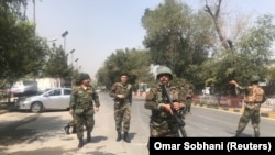 Security forces near the site where the bomb exploded in the center of Kabul.