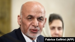 Afghan President Ashraf Ghani delivers a speech next to his wife, Rula, during a United Nations conference on Afghanistan in Geneva on November 28.