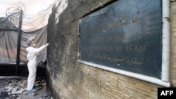 A forensic expert works on a wall of the Iranian Embassy after it was hit by a double suicide bombing in Beirut on November 19.