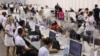 Election workers process ballots papers at an indoor sports and concert arena in Sofia on July 11. 