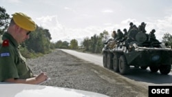 An officer from the OSCE Mission to Georgia observes the withdrawal of Russian troops, October 2008.