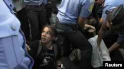 Russian police detain opposition activists during a protest rally in central Moscow on August 12.