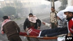 A Palestinian youth is carried on a stretcher following artillery shelling from Israel into Gaza City on January 14.