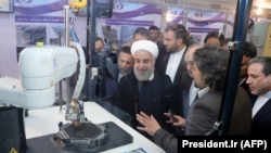 Iranian President Hassan Rohani (center) attends a ceremony to mark National Nuclear Technology Day in Tehran on April 9.