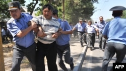 Police detain opposition supporters during rally in central Bishkek.