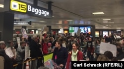 Demonstrators protest President Donald Trump's travel ban at Dulles airport on January 30.