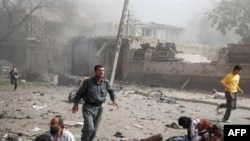 Survivors run past fallen bystanders at the scene of the Indian Embassy bombing in Kabul