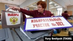 An official prepares ballot boxes in Vladivostok for the March 18 presidential election.