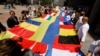 European lawmakers and Ukrainian representatives unfurl a 30-meter-long Ukrainian flag outside the EU Parliament on June 23, the day Ukraine and Moldova were given official candidate status for the bloc. 