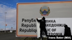 Changing the signs at Bogorodica on the North Macedonia-Greece border. 