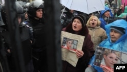 Supporters of Yulia Tymoshenko hold pictures of the opposition leader during a rally in front of a court in Kyiv on December 20.