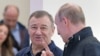 Russian President Vladimir Putin (right) speaks with Arkady Rotenberg as they attend the opening ceremony for a bridge linking the Crimean Peninsula to Russia, in Kerch on May 15.