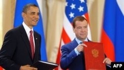 U.S. President Barack Obama (left) and Russian President Dmitry Medvedev exchange the freshly signed "New START" documents at Prague Castle in April 2010.