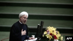 Iranian President Hassan Rohani speaks during a parliament session to elect the cabinet members in Tehran on August 15