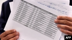 Ukrainian journalist and member of parliament Serhiy Leshchenko holds copies of accounting ledgers as he speaks to the media during a news conference in Kyiv about alleged under-the-table payments that were earmarked for Paul Manafort, who is now U.S. presidential candidate Donald Trump's campaign chairman.