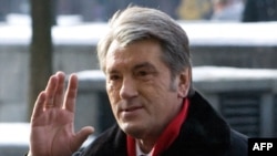 President Viktor Yushchenko waves as he greets people after casting his ballot at a polling station in Kyiv.