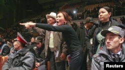 Spectators during a November 17 court session held in a Bishkek sports arena react during the trial.