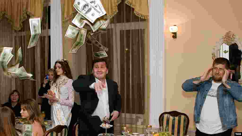 Kadyrov (right) watches as a man tosses $100 bills at a restaurant in Gudermes during a celebration to honor the winner of the republic&#39;s first &quot;Beauty of Chechnya&quot; pageant in 2006.