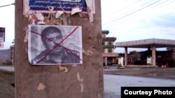 A defaced poster of former Afghan warlord Abdul Rashid Dostum posted in Kabul last year.