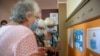 A woman checks instructions at a voting station in Bulgaria's inconclusive July election. Voters return to the polls on November 14.