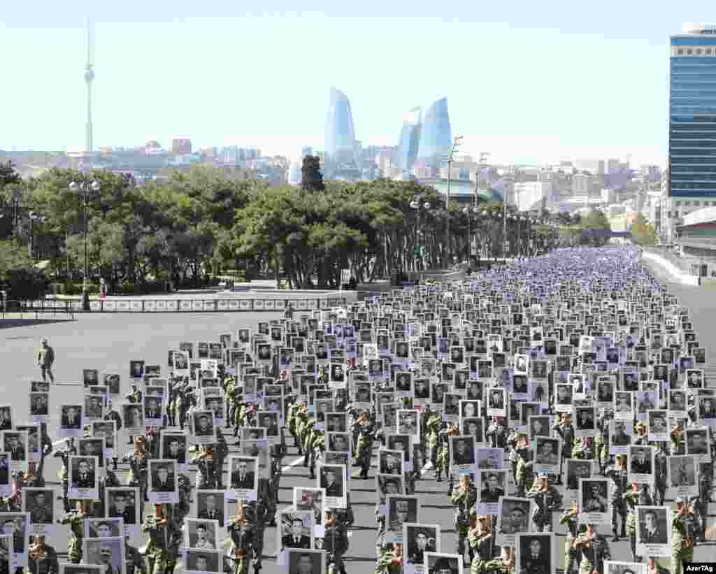 Thousands of soldiers march through Baku on September 27. The marchers are holding placards depicting soldiers and civilians killed in 2020, the most intense escalation since the 1994 truce that turned the war between Armenia and Azerbaijan over the Nagorno-Karabakh region into a &quot;frozen conflict.&quot; 