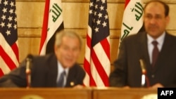 U.S. President George W. Bush (left) ducks to avoid a shoe thrown at him by Iraqi journalist Muntazer al-Zaidi.