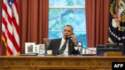 This official White House photograph, released on September 27, shows President Barack Obama talking with Iranian President Hassan Rohani during a phone call in the Oval Office, the first direct contact between presidents from both countries in over 30 years. 