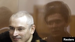 Mikhail Khodorkovsky sits before a court session starts in Moscow court in April.