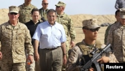 U.S. Secretary of Defense Leon Panetta (center) leaves a meeting with ISAF troops during his Afghanistan visit on March 14.