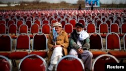 Supporters of presidential candidate Abdullah Abdullah wait for the start of an election rally in Parwan Province on March 20.