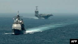 A picture released by the U.S. Navy shows the guided-missile cruiser "USS Gettysburg" (left) and the aircraft carrier "USS Harry S. Truman" transiting the Strait of Gibraltar earlier this month on their way to the Mediterranean Sea.