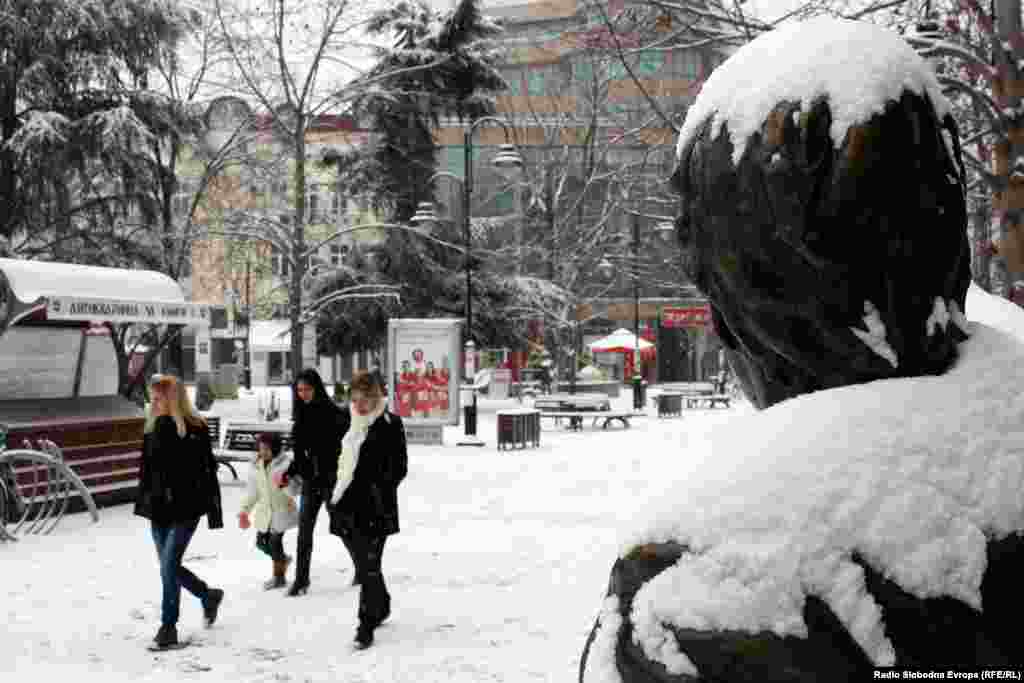 Pedestrians brave the cold in the Macedonian capital, Skopje.