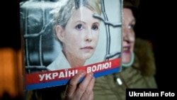 A supporter of Yulia Tymoshenko holds up her picture during a rally in Kyiv in November.