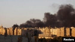 Heavy smoke covers the skyline of Aleppo city after a bombing earlier this week. 