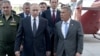 Russian President Vladimir Putin (left) walks with Tatarstan President Rustam Minnikhanov (right) and other officials on a visit to Kazan in May 2019. Soon, only one will be president.